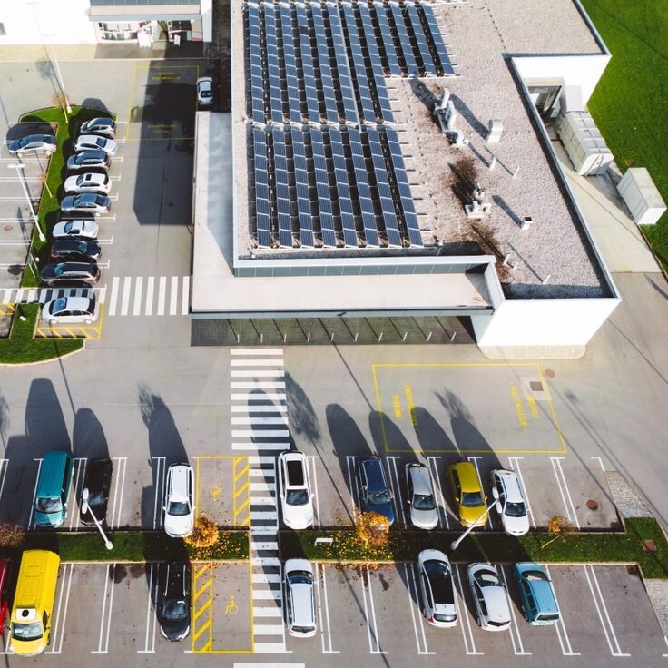 Office building with solar panels and parking lot