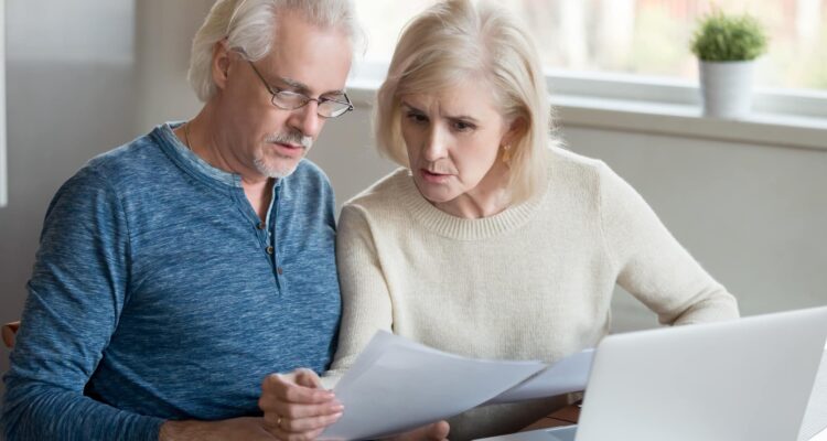 Couple Looking At A High Electric Bill